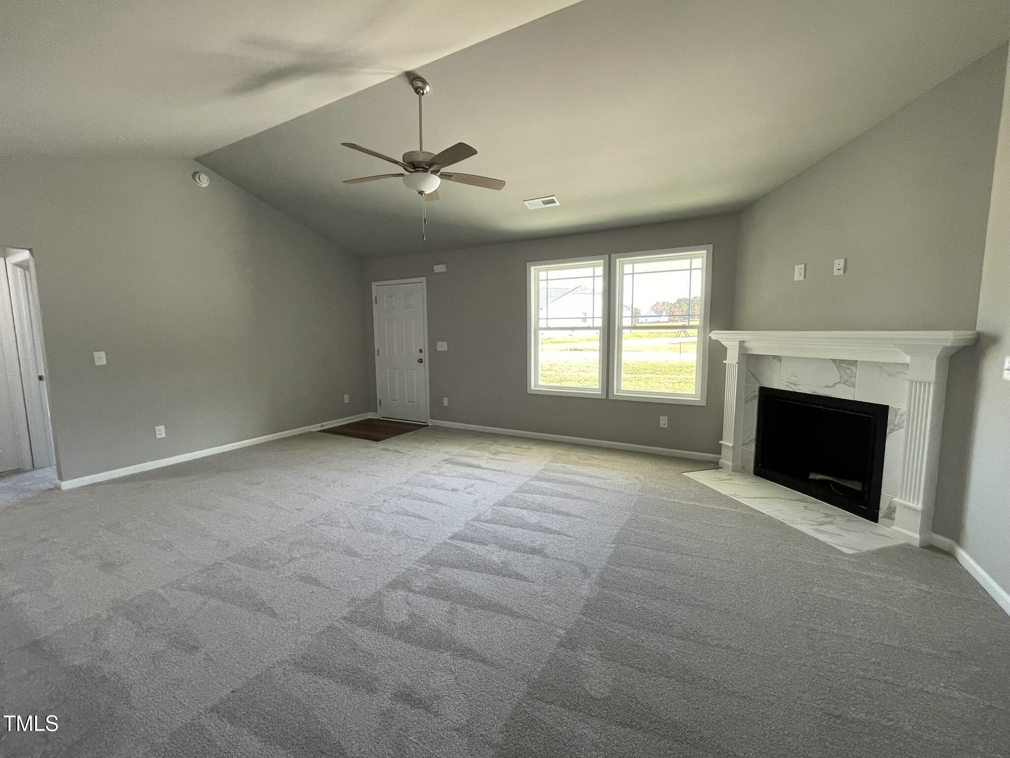 79 Tulipfield Way Benson, NC 27504 - Photo 6 of 19 an empty room with windows and fireplace