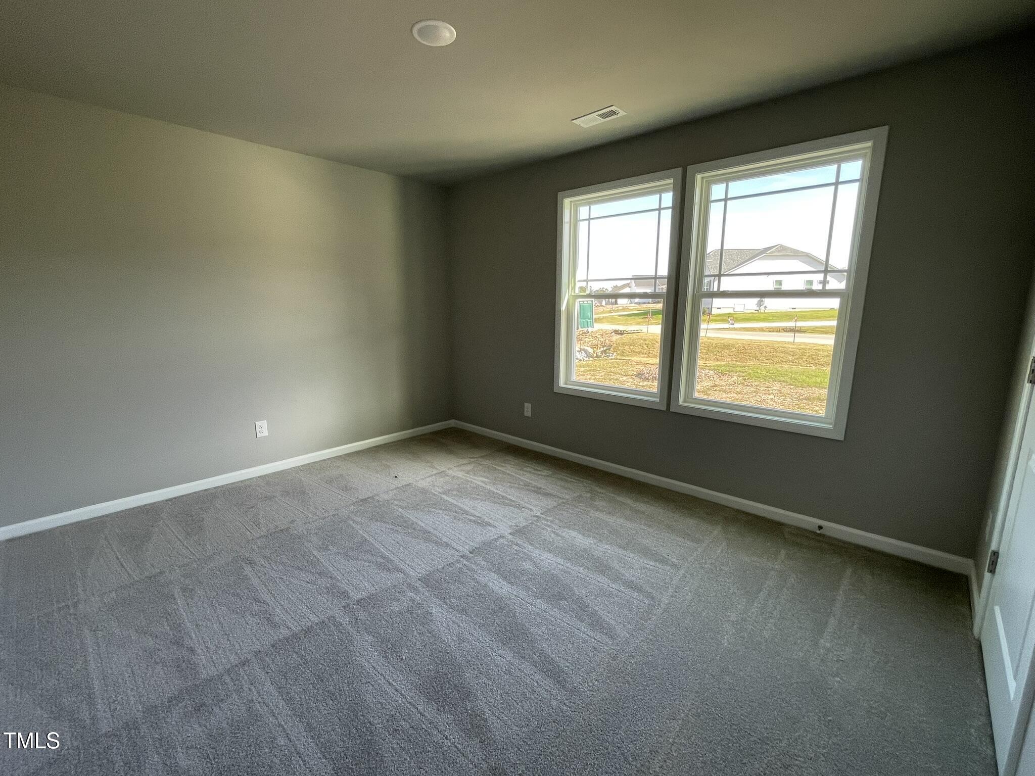 79 Tulipfield Way Benson, NC 27504 - Photo 7 of 19 a view of an empty room with a window