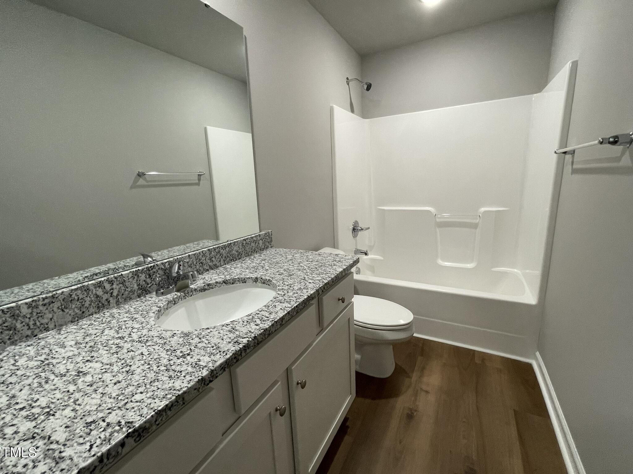 79 Tulipfield Way Benson, NC 27504 - Photo 8 of 19 a bathroom with a granite countertop sink toilet and shower
