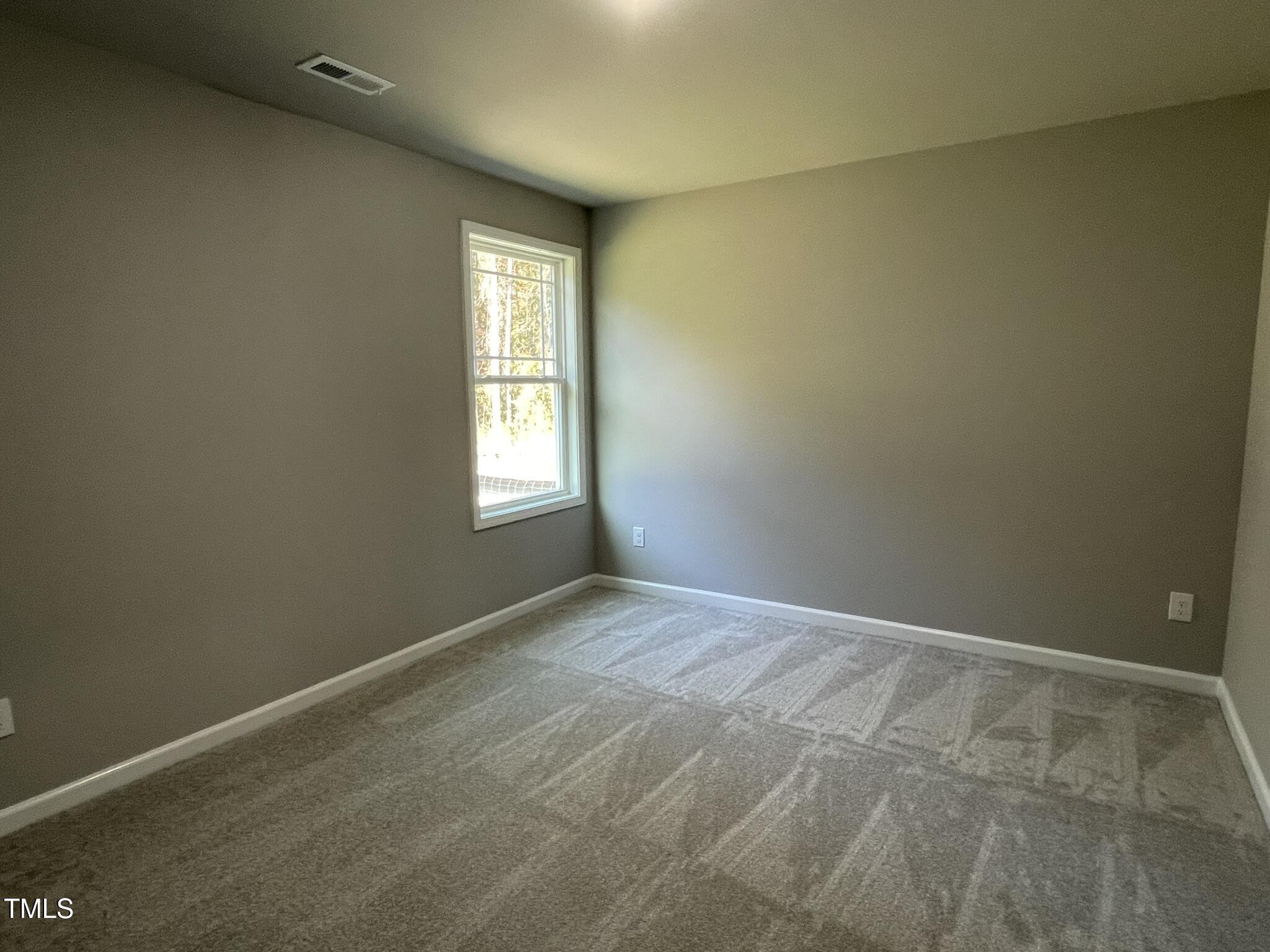 79 Tulipfield Way Benson, NC 27504 - Photo 9 of 19 a view of an empty room and window