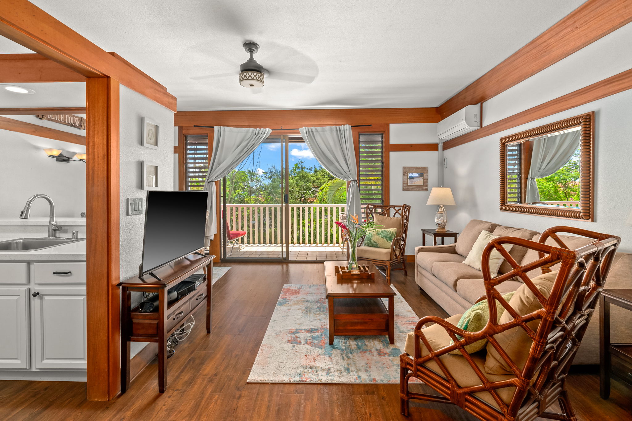 2253 Poipu Road, Unit 411 Koloa, HI 96756 - Photo 5 of 20 a living room with furniture a large window with wooden floor