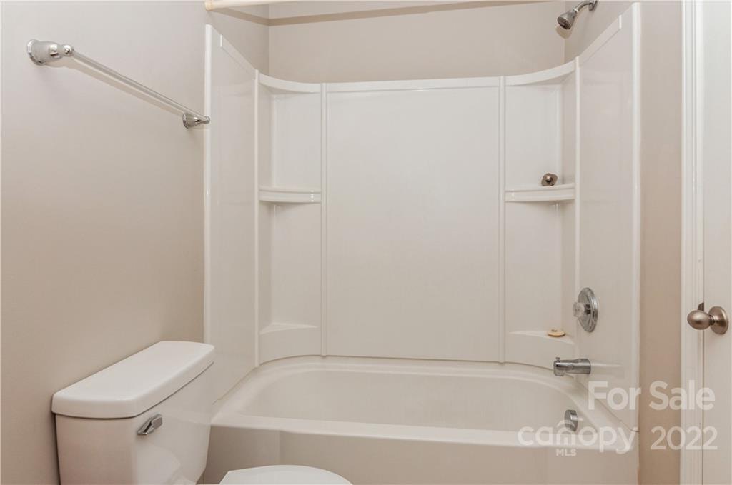 447 Hunters Dance Road, Unit 27 Fort Mill, SC 29708 - Photo 23 of 38 a white bath tub sitting next to a white toilet and a shower