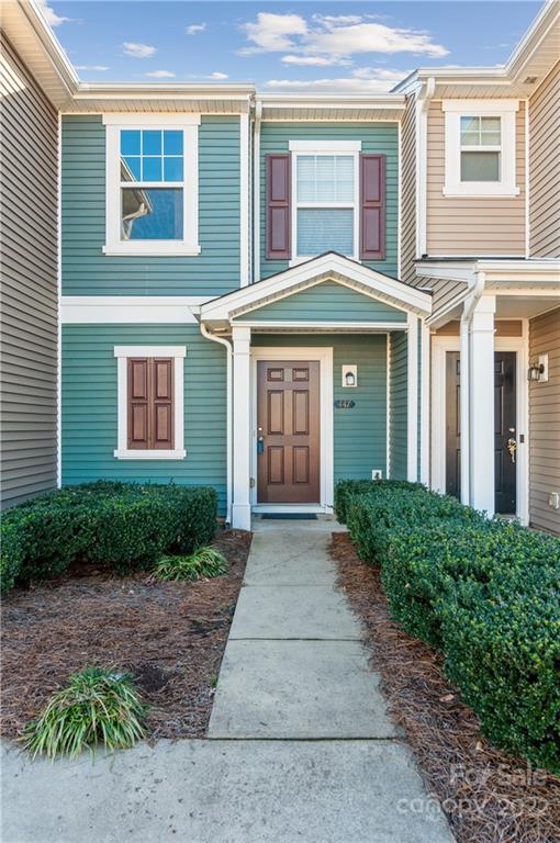 447 Hunters Dance Road, Unit 27 Fort Mill, SC 29708 - Photo 3 of 38 a front view of a house with garden
