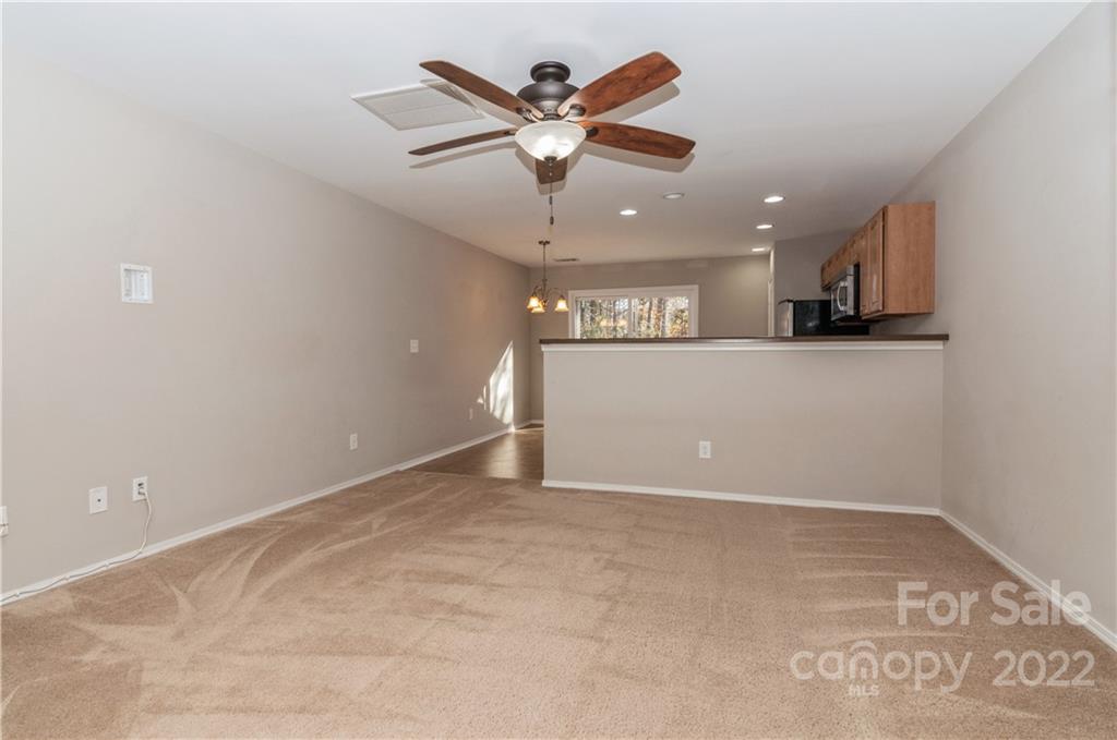 447 Hunters Dance Road, Unit 27 Fort Mill, SC 29708 - Photo 10 of 38 an empty room with ceiling fan and window