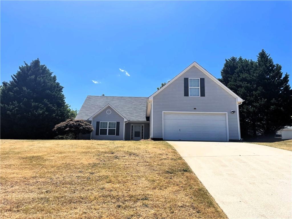 7320 Pea Ridge Place Gainesville, GA 30506 - Photo 1 of 1 a front view of house with yard and trees in the background