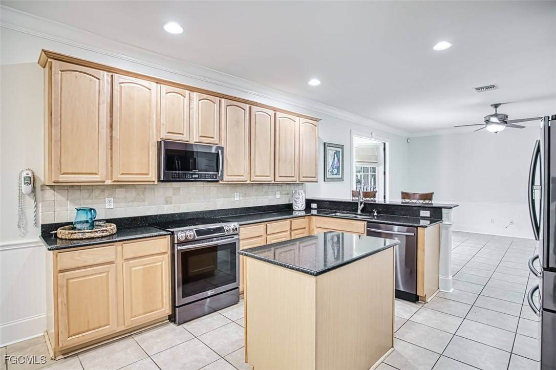 8916 Fawn Ridge Drive Fort Myers, FL 33912 - Photo 12 of 49 a kitchen with stainless steel appliances granite countertop a stove a sink and a microwave