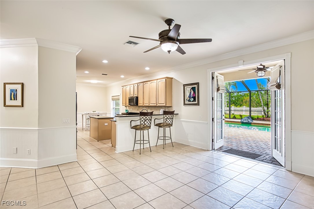 8916 Fawn Ridge Drive Fort Myers, FL 33912 - Photo 15 of 49 a view of a kitchen with furniture and floor to ceiling window