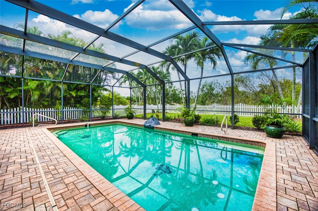 8916 Fawn Ridge Drive Fort Myers, FL 33912 - Photo 18 of 49 a view of swimming pool with a patio and plants