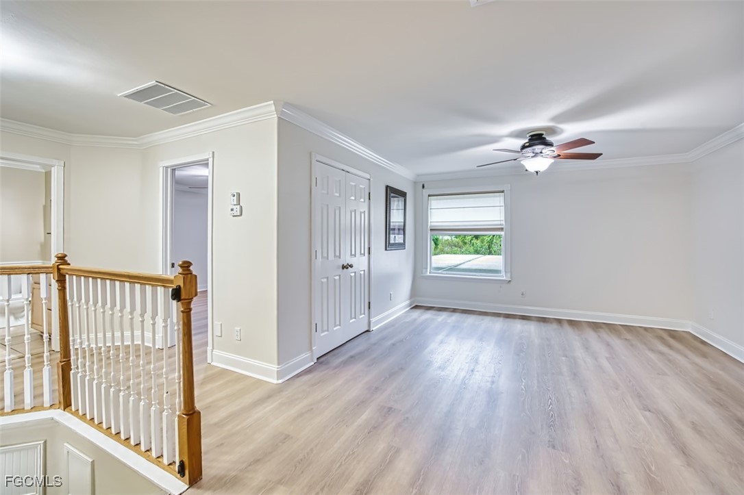 8916 Fawn Ridge Drive Fort Myers, FL 33912 - Photo 23 of 49 wooden floor in an empty room with a window