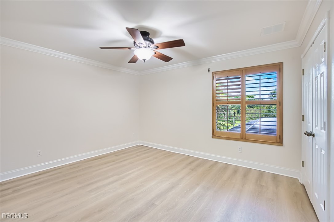 8916 Fawn Ridge Drive Fort Myers, FL 33912 - Photo 31 of 49 wooden floor in an empty room with a window