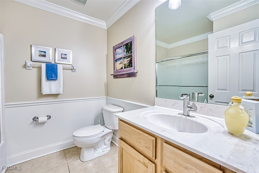 8916 Fawn Ridge Drive Fort Myers, FL 33912 - Photo 33 of 49 a bathroom with a granite countertop sink mirror vanity and toilet