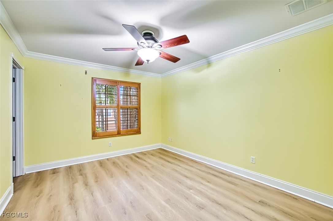 8916 Fawn Ridge Drive Fort Myers, FL 33912 - Photo 35 of 49 a view of an empty room with wooden floor and a window