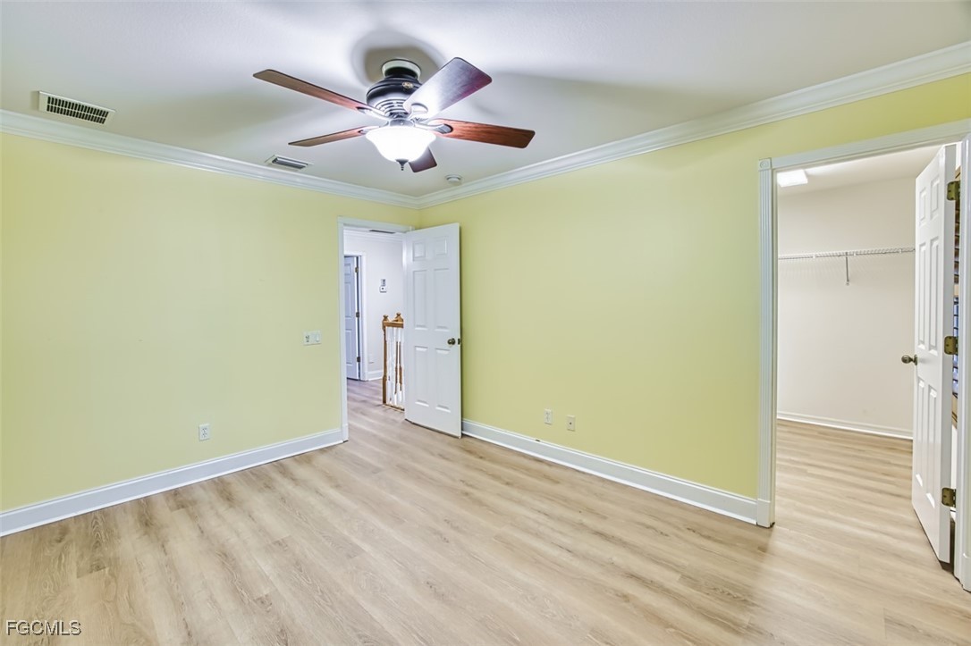 8916 Fawn Ridge Drive Fort Myers, FL 33912 - Photo 36 of 49 a view of an empty room with wooden floor