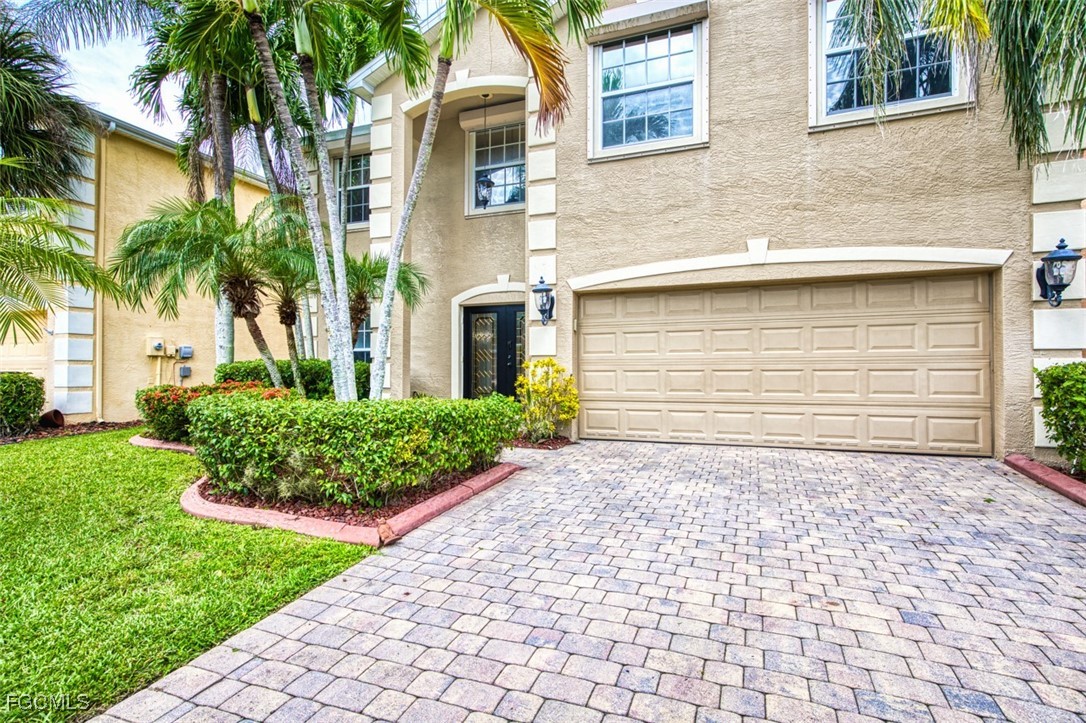 8916 Fawn Ridge Drive Fort Myers, FL 33912 - Photo 4 of 49 a front view of a house with a garden