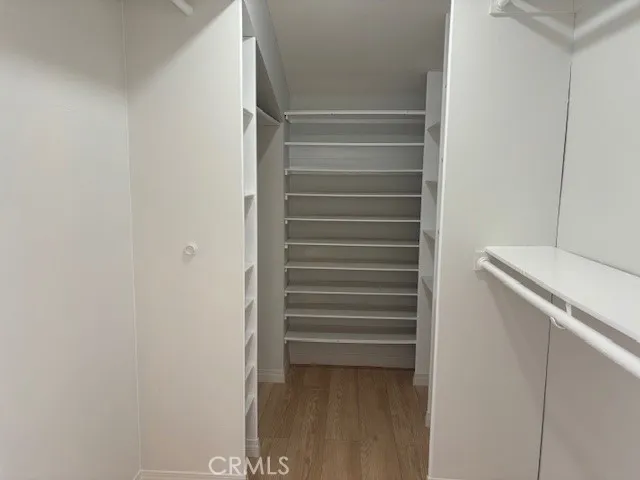 a view of walk in closet with empty racks