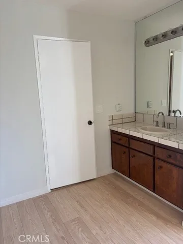 a spacious bathroom with a double vanity sink and a mirror