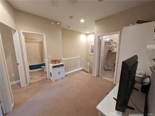 a view of a livingroom with furniture and a refrigerator