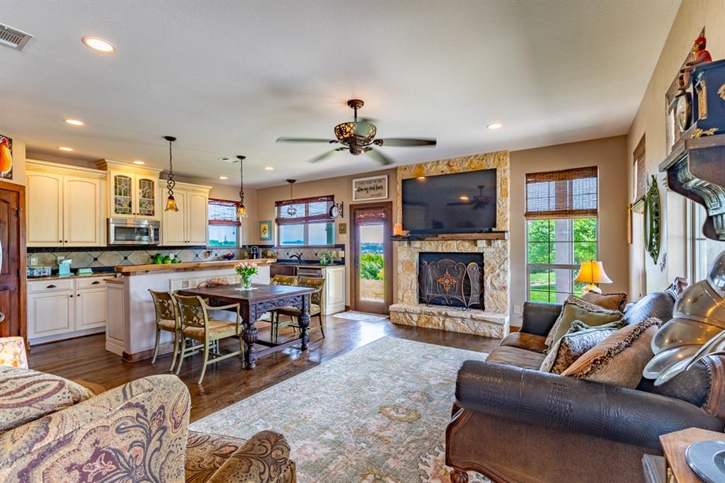 7060 Hells Gate Loop Strawn, TX 76475 - Photo 39 of 40 a living room with furniture a fireplace and a flat screen tv