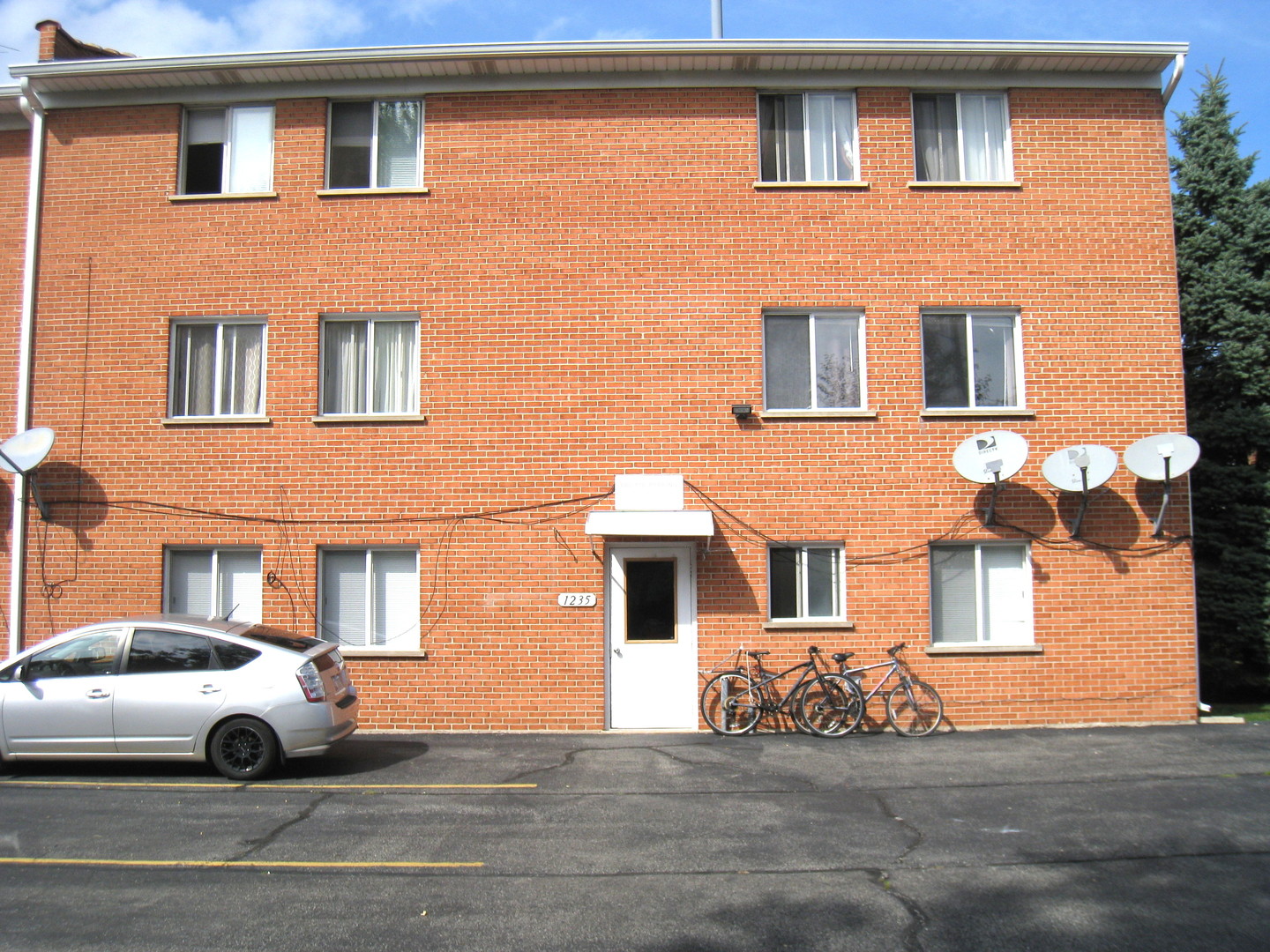 1235 Harding Avenue, Unit 302 Des Plaines, IL 60016 - Photo 22 of 22 a front view of a house with parking space