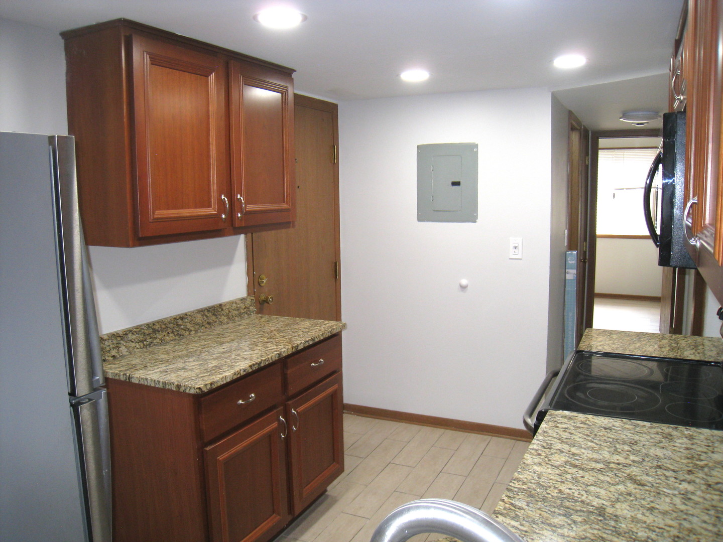1235 Harding Avenue, Unit 302 Des Plaines, IL 60016 - Photo 5 of 22 a kitchen with a refrigerator and countertop