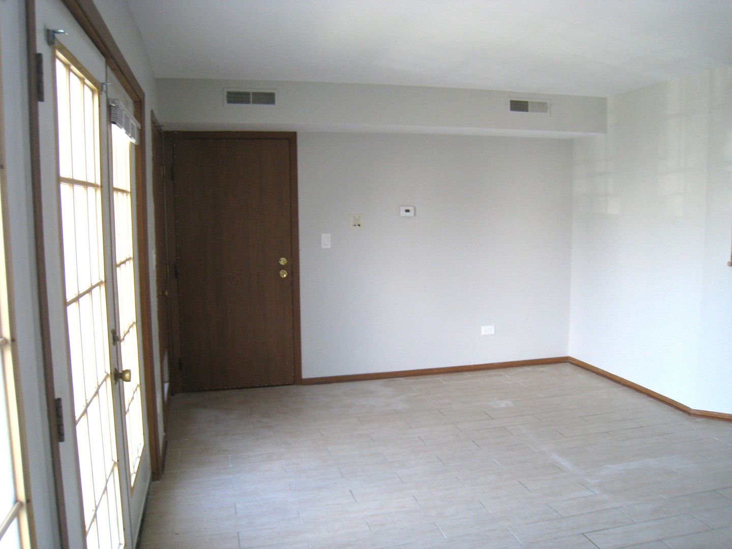 1235 Harding Avenue, Unit 302 Des Plaines, IL 60016 - Photo 9 of 22 a view of an empty room with a window