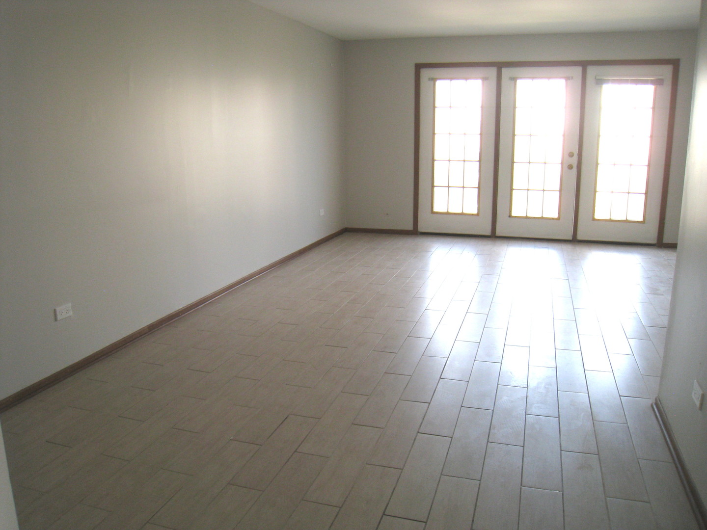 1235 Harding Avenue, Unit 302 Des Plaines, IL 60016 - Photo 10 of 22 an empty room with wooden floor and windows