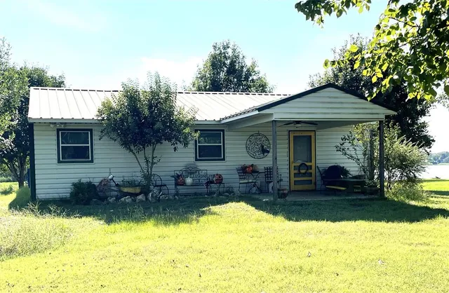 a view of a house with swimming pool and furniture