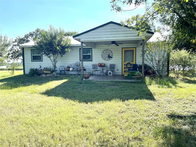 a view of a deck with a bench and a tree