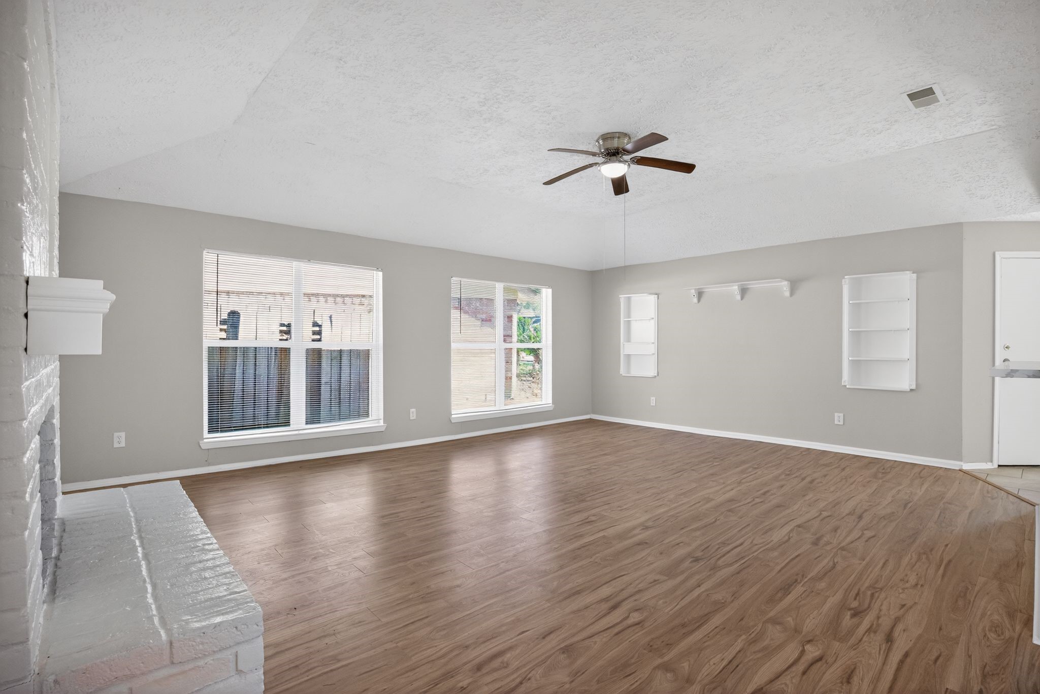 7311 Postwick Court Houston, TX 77095 - Photo 11 of 36 a view of an empty room with wooden floor and a window