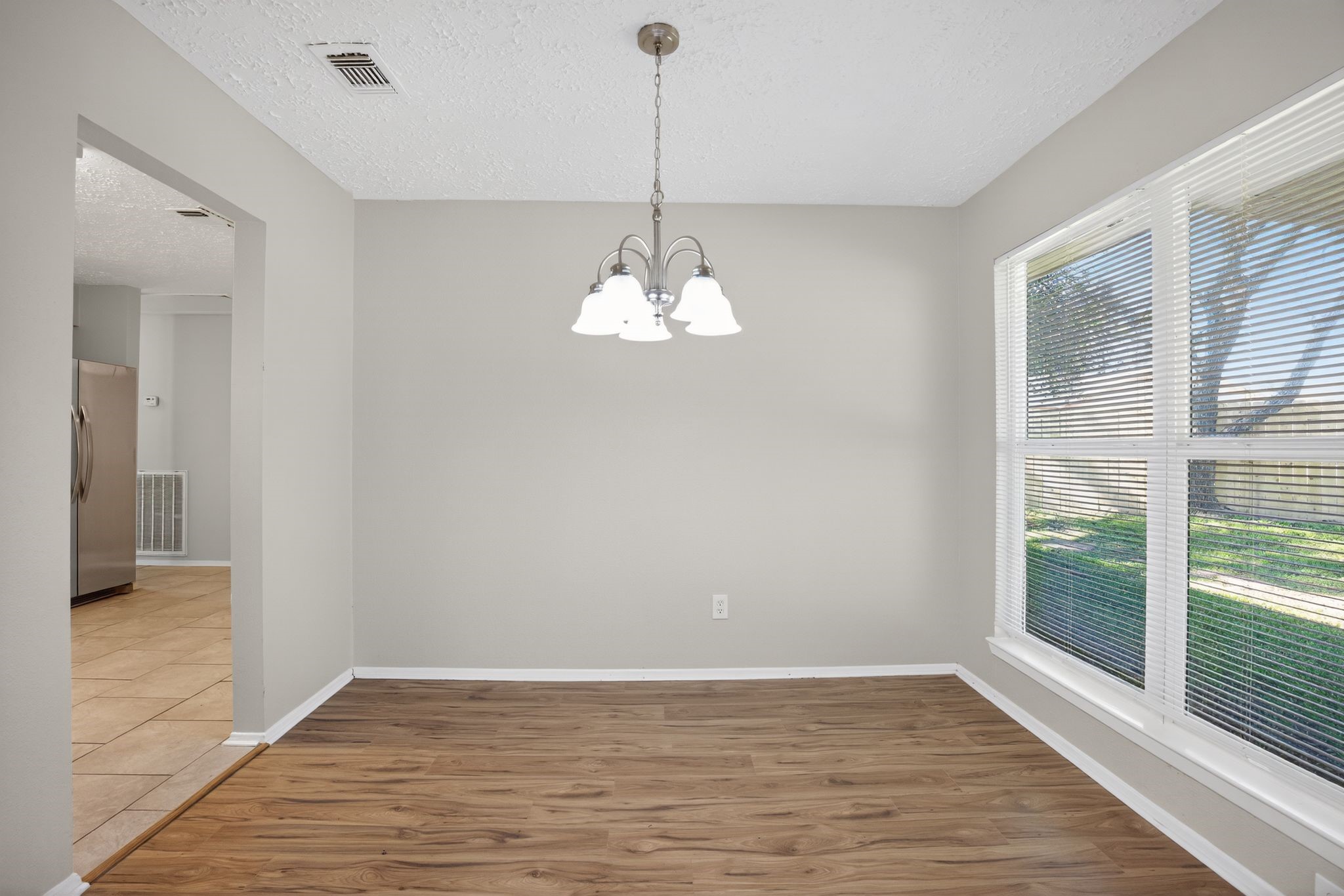 7311 Postwick Court Houston, TX 77095 - Photo 14 of 36 a view of a livingroom with a chandelier wooden floor and a chandelier
