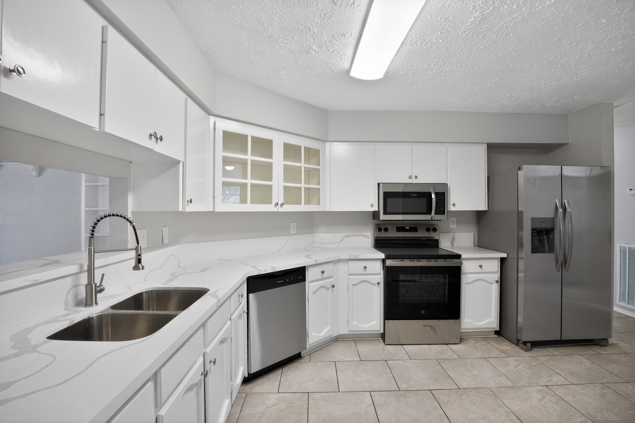 7311 Postwick Court Houston, TX 77095 - Photo 15 of 36 a kitchen with a sink cabinets and stainless steel appliances