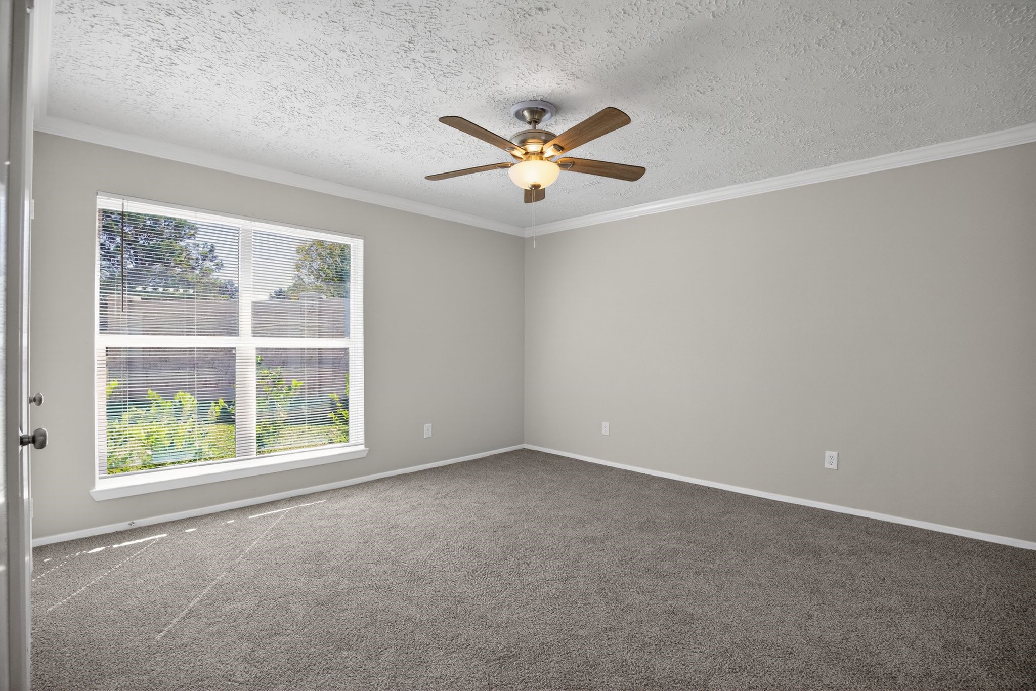 7311 Postwick Court Houston, TX 77095 - Photo 21 of 36 an empty room with a window and a ceiling fan