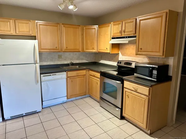 a kitchen with a sink stove and microwave