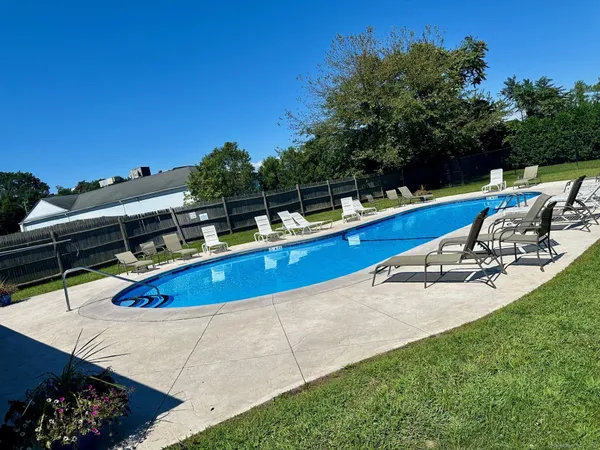 a view of a swimming pool with chairs