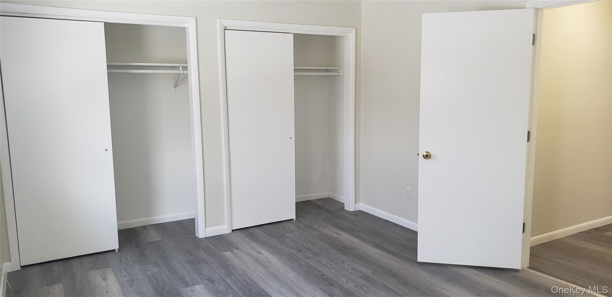 42 Upper Ferndale Road, Unit B Liberty, NY 12754 - Photo 11 of 18 Unfurnished bedroom featuring multiple closets and dark wood-style flooring