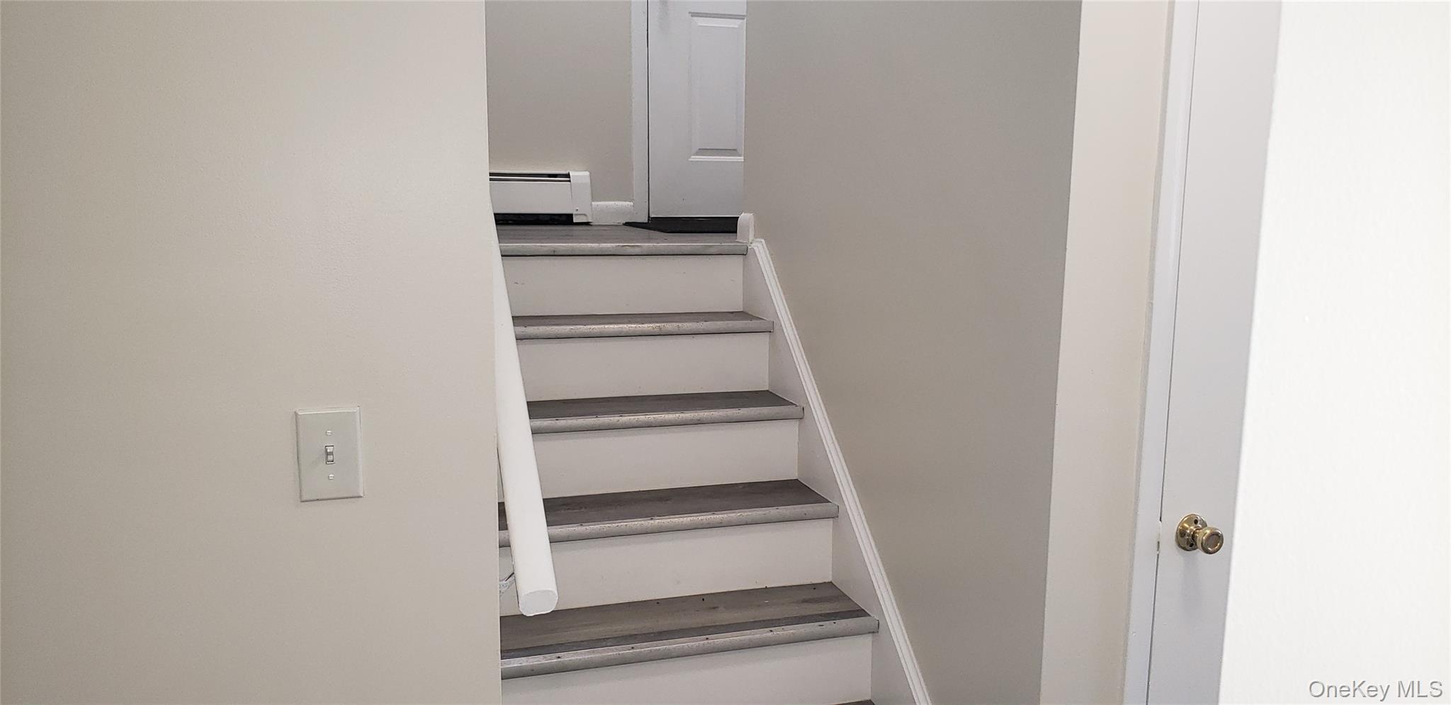 42 Upper Ferndale Road, Unit B Liberty, NY 12754 - Photo 14 of 18 Stairway with a baseboard heating unit