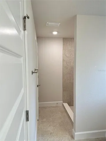 a bathroom with a shower and a glass door
