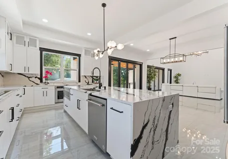 a kitchen with counter top space appliances and windows