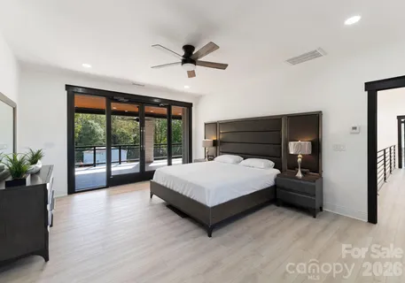 a spacious bedroom with a bed and a large window