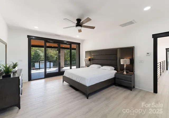 a spacious bedroom with a bed and a large window