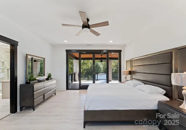 a bedroom with a bed mirror and window