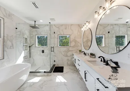 a bathroom with a double vanity sink mirror bathtub and shower