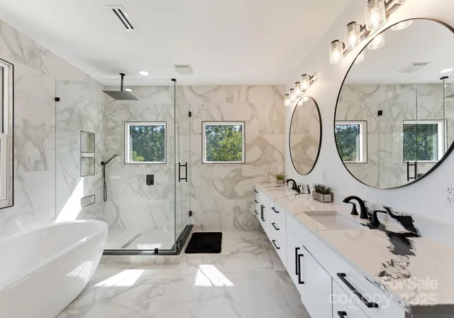 a bathroom with a double vanity sink mirror bathtub and shower
