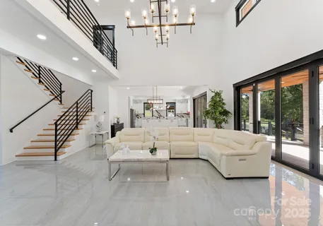 a living room with furniture ceiling fan and a large window