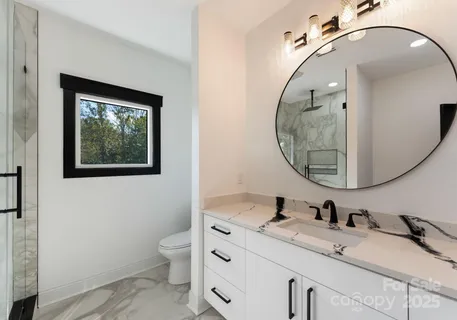 a bathroom with a toilet a sink and mirror