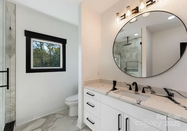 a bathroom with a toilet a sink and mirror