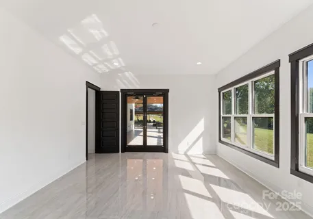 a view of an empty room with windows and outer view