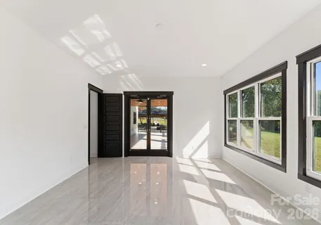 a view of an empty room with windows and outer view