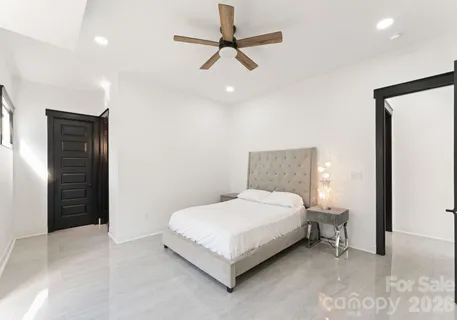 a bedroom with a bed and a ceiling fan