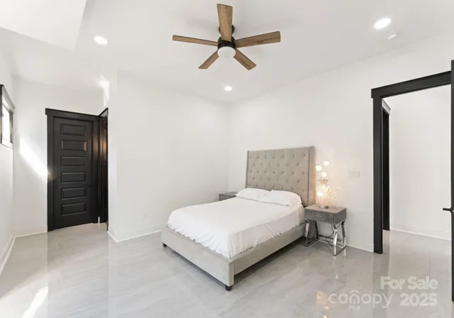 a bedroom with a bed and a ceiling fan
